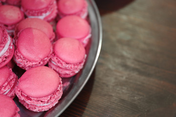 Pink macaroons on plate closeup