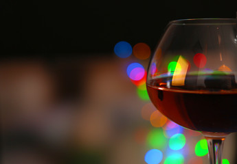 Wine glass with bokeh on dark background
