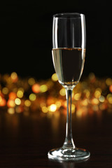 A glass of champagne with bokeh on dark background