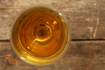 Glass of wine on wooden table. Top view