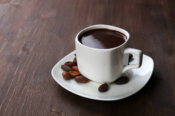 Cacao with beans and chocolate on wooden background