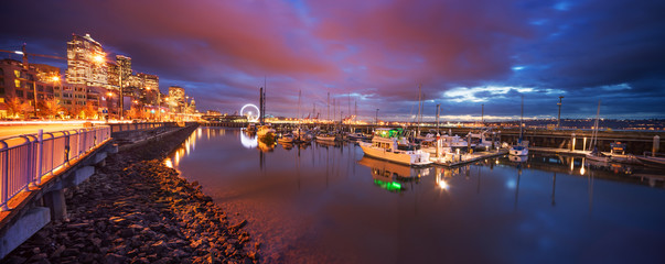 sailboats parking in bay of city in cloudy sky at night