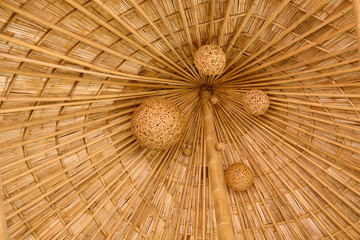 Bamboo shingle roof with woven bamboo hanging folk art