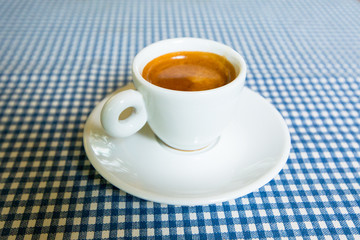 A cup of espresso on a table.