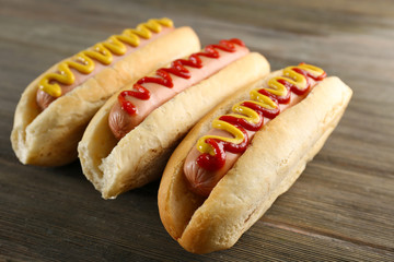 Tasty hotdogs on wooden background