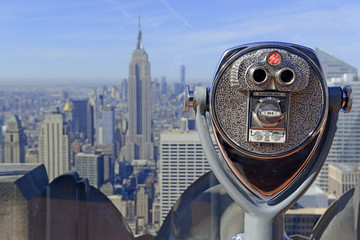 Fototapeta na wymiar Viewfinder peering out to the Manhattan skyline, New York City, with focus on viewfinder and purposely blurring the background buildings