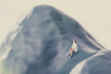 ベンチに寂しく座っている若い女性