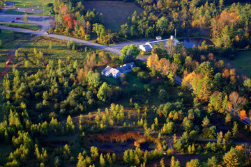 Fototapeta na wymiar An aerial view of a hot air balloon floating over the Vermont country side ..