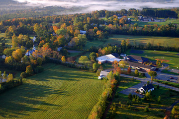 An aerial view of a hot air balloon floating over the Vermont country side ..