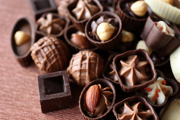 Appetizer chocolate candies on wooden background