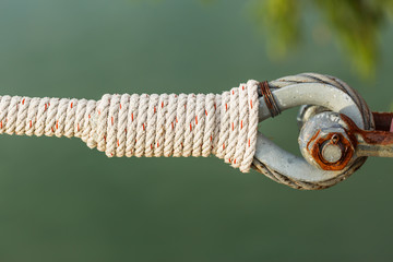 rusty shackle connect the sling and rope tied knot in nature bac