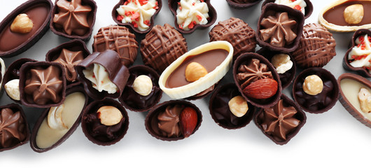 Delicious chocolate candies on white background