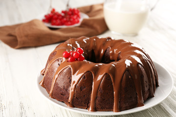 Chocolate cake with a bottle of milk on a table