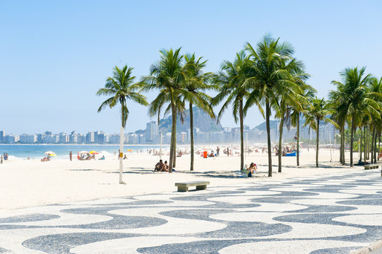 Scenic view of Copacabana Beach with palm trees at the Leme end of the beach in Rio de Janeiro, Brazil