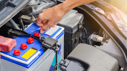 Open cap of battery for add distilled water by hand, maintenance
