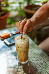 Man holding straw on iced coffee