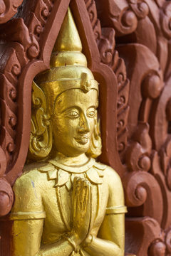 Row of Buddha statues on Buddhist temple wall