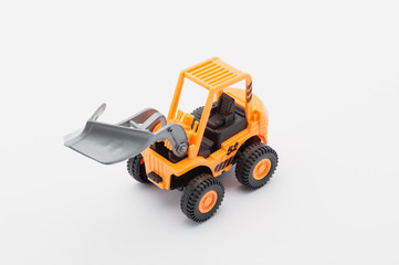 Fototapeta na wymiar Orange tractor toy