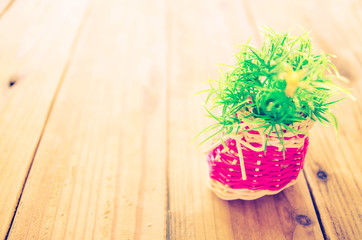 Artificial flowers on wooden vintage background.