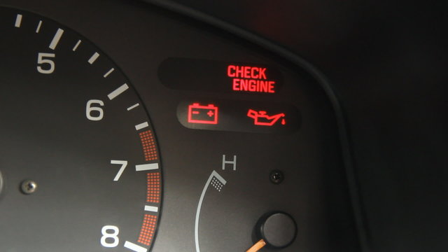 Flashing check engine light sign warning on car dashboard