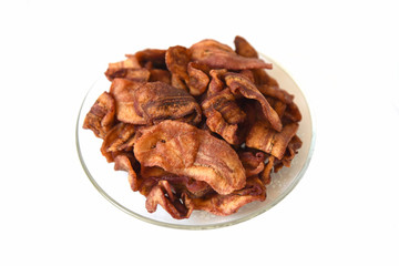 crispy sliced banana chips in glass dish on white ground