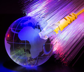glass earth with network against fiber optic background