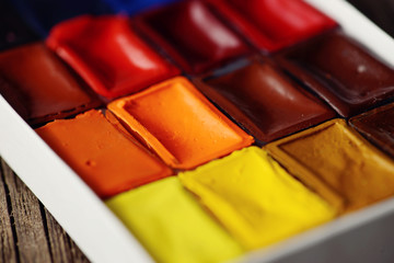 watercolor in box on wooden table