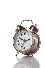 Old metal alarm clock on a white background