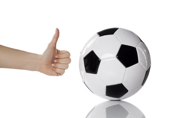 soccer ball and female hand with thumb up