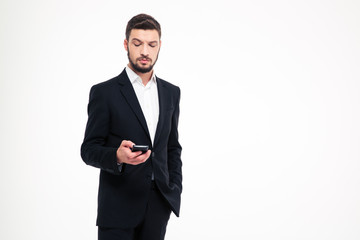 Serious businessman using smartphone