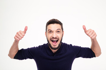 Fototapeta premium Elated excited young happy man shouting and showing thumbs up