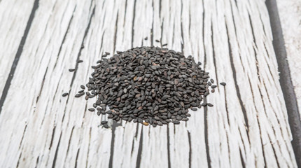 Black sesame seed over wooden background