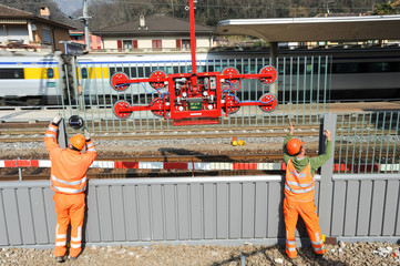 Workers during the installation of noise barriers on the railway