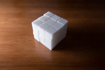 stacked sugar cubes on wooden table