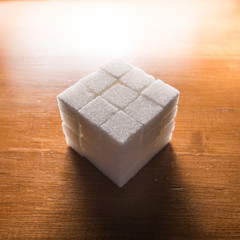 stacked sugar cubes on wooden table