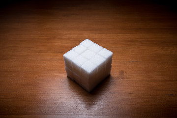 stacked sugar cubes on wooden table