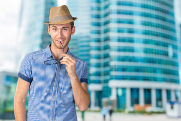 Young handsome man in glasses and hat