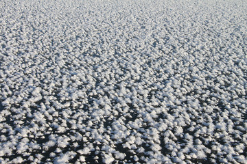Snow cover of a freakish form on ice of the frozen river