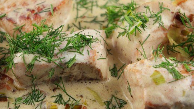 Fish soup with salmon, cream and parsley in a frying pan