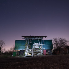 old wooden caravan at night