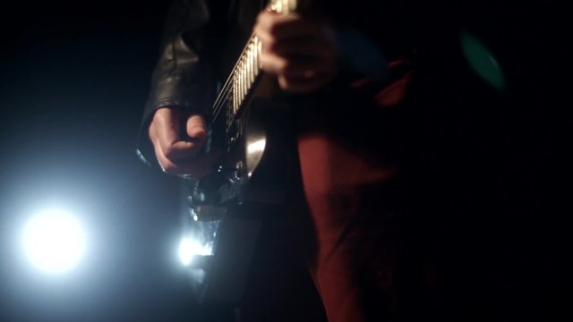 rock concert, man playing guitar on black background