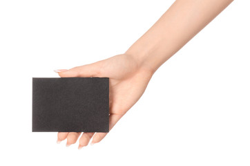 Branding and advertising theme: beautiful female hand holding empty black paper card isolated on white background