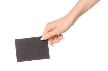 Obraz premium Branding and advertising theme: beautiful female hand holding empty black paper card isolated on white background