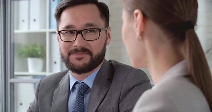 Asian businessman negotiating with his female colleagues 