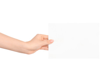 Branding and advertising theme: beautiful female hand holding a blank white paper card isolated on white background