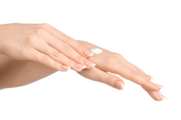 Fototapeta premium Health and body care theme: beautiful female hand with white cream isolated on a white background, hand massage
