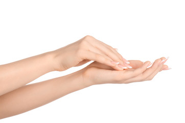 Health and body care theme: beautiful female hand with white cream isolated on a white background, hand massage