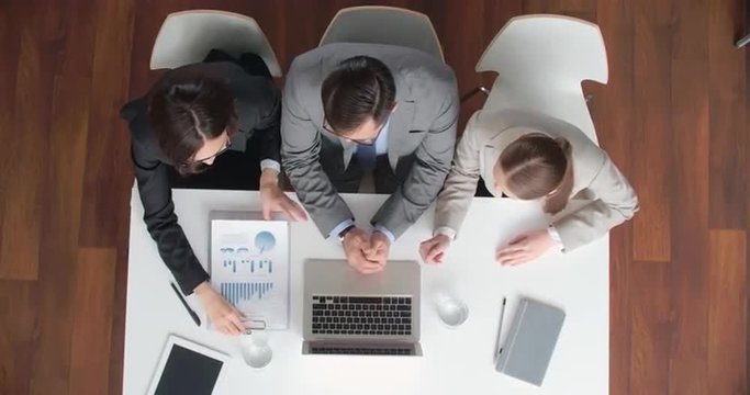 High angle view of business team discussing market information