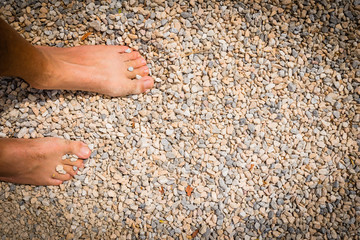 close up of male feet on the sand