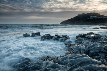 Obraz premium Blue hour at Bracelet Bay Blue Flag and Seaside Award winning Bracelet Bay beach is just around Mumbles' head on the Gower peninsula in South Wales. 